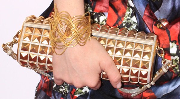 Amanda Seyfried showing off her jewelry and gold clutch handbag