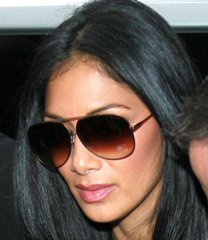 Nicole Scherzinger poses for pictures and signs autographs for fans outside the BBC Radio 1 Studios in London on October 28, 2011