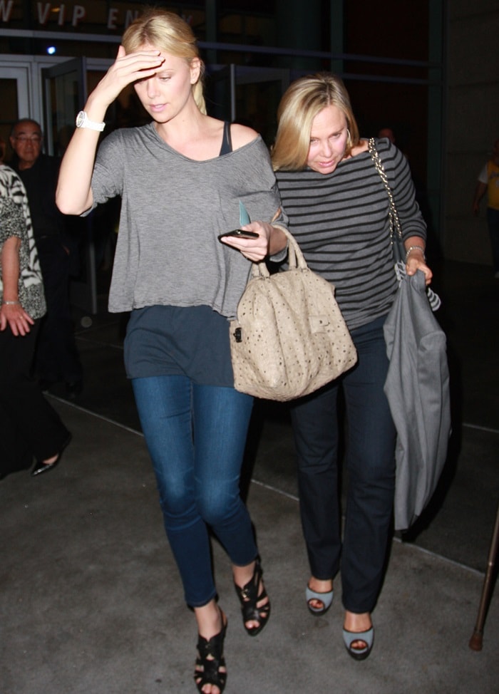 Charlize Theron Charlize layered on a tee over a tank paired with dark denims and black sandal booties
