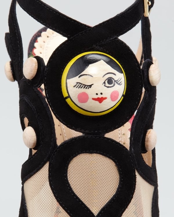 This shoe features a cool light wooden heel and platform with black suede straps and ultra cool Matryoshka doll face details