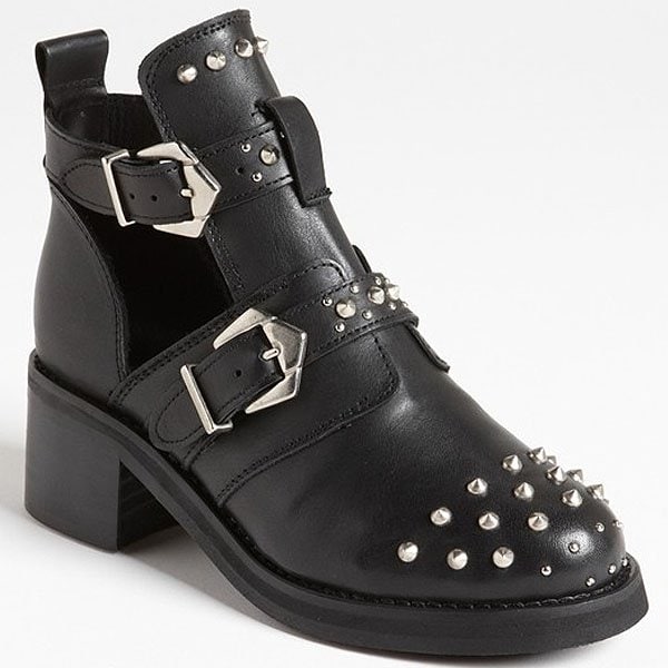 Silvery studs splash a chunky leather boot crafted with side cutouts that flash a little skin