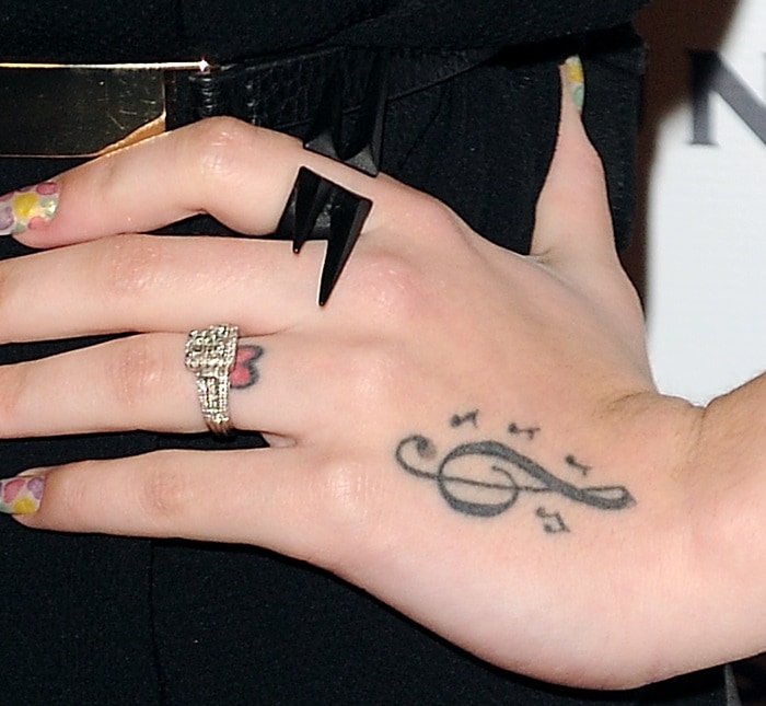Cher Lloyd showing off her hand tattoos and rings