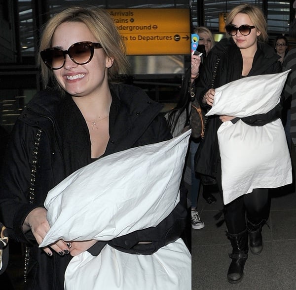 Demi Lovato clutching a large pillow