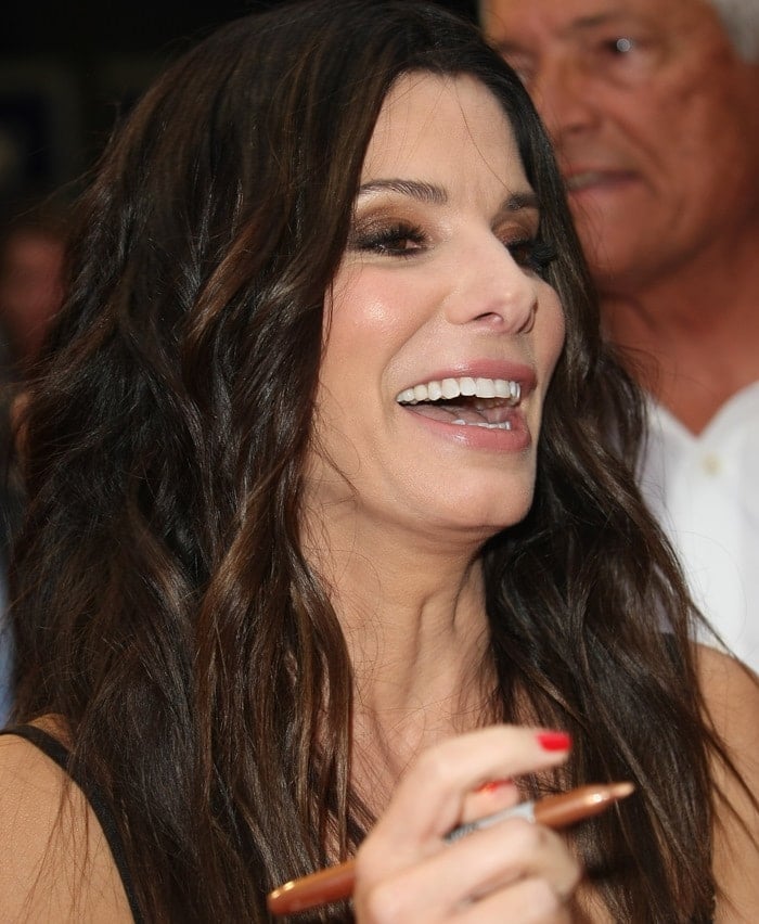 Sandra Bullock in a black backless Victoria Beckham spring 2013 dress at the U.K. premiere of her latest movie, The Heat, in London on June 13, 2013
