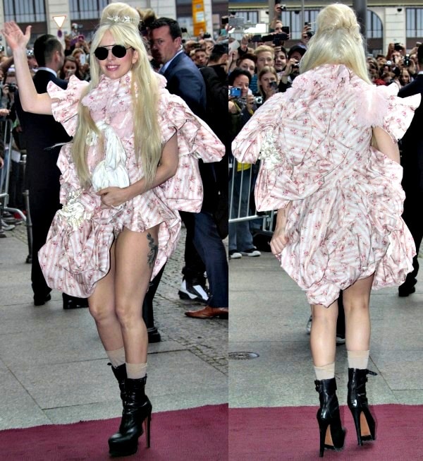 Lady Gaga caused quite a stir as she arrived at the Ritz Carlton Hotel in Berlin wearing a Victorian-style outfit that showed off her legs and a tattoo of a unicorn