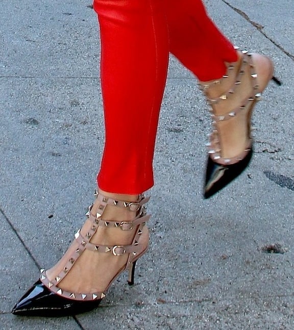 Rebecca Romijn sporting red leather skinnies and a pair of studded pumps from Valentino while shopping around Beverly Hills, California, on October 8, 2013
