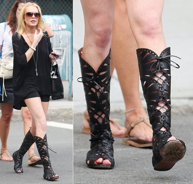 Lindsay Lohan wearing a little black dress and knee-high Azzedine Alaia lace-up gladiator strappy boots, visits Ina in SoHo on August 19, 2009