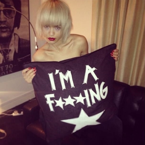 Rita Ora revealed her humorous side in an almost naked picture with a large cushion that read "I'M A F***ING STAR,"