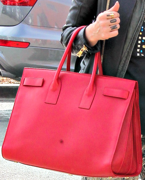 Jessica Alba carried a scene-stealing bright red leather "Sac de Jour" bag from Saint Laurent