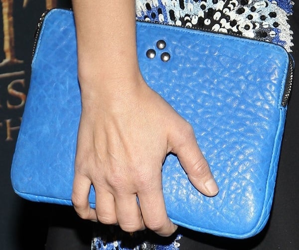 Kristen Bell accessorized with a studded blue leather iPad case 
