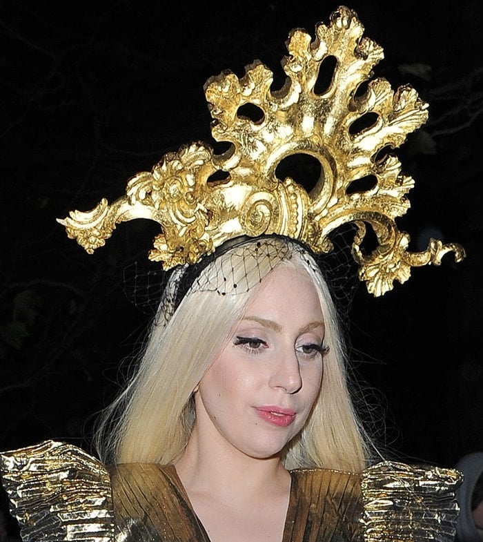 Lady Gaga wearing a gold dress with a matching gold headpiece as she returns to her hotel in London on December 4, 2013