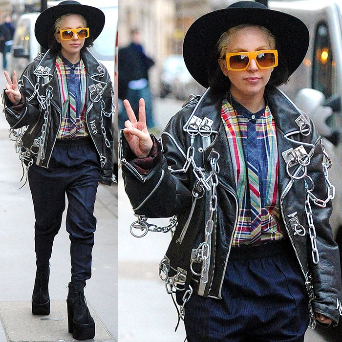 Lady Gaga sported a wide-brimmed hat, square-framed yellow sunglasses, and a black leather jacket laden with heavy metal rings and chains