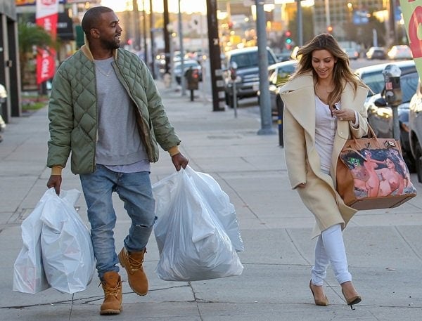 Kim Kardashian showing off her Christmas gift from her fiance, Kanye West, while shopping in Los Angeles on December 26, 2013