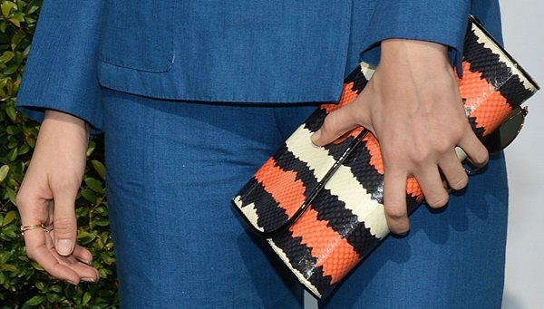 Caitlin Fitzgerald toting a multicolor clutch by Christian Louboutin