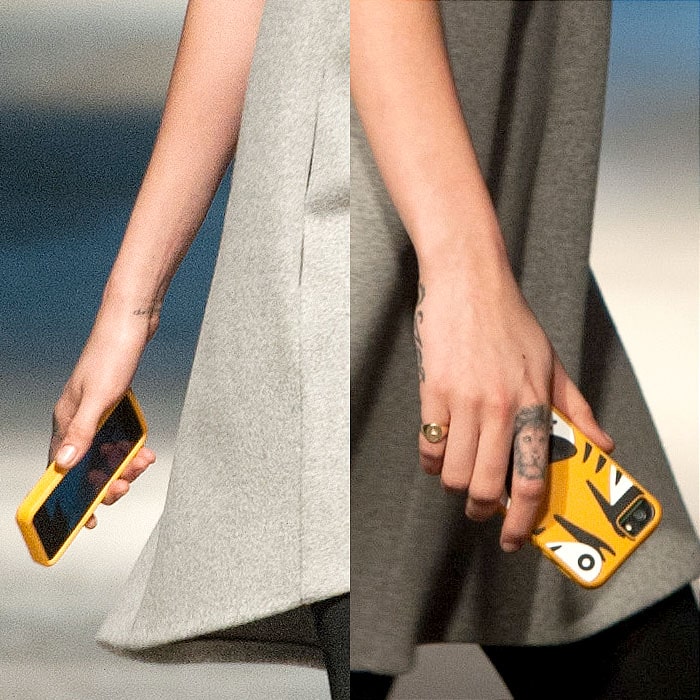 The tiger-print-encased phone in Cara Delevingne's hand, which the model carried on the Giles Fall 2014 runway