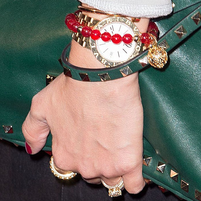Jessica Alba wearing red, green, and gold bracelets