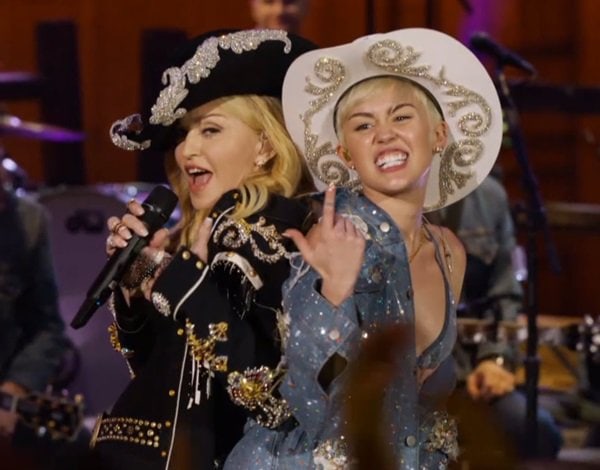 Miley Cyrus performing on stage with Madonna