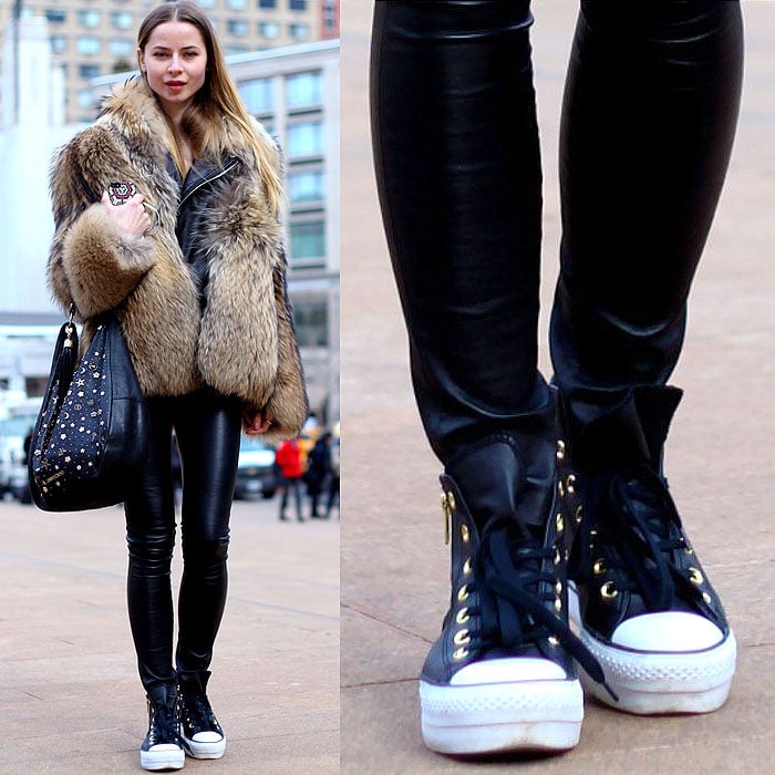 Model wears Chuck Taylors with a fur coat