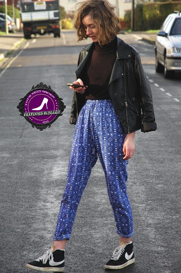 Try wearing your high-waisted printed trousers with a solid-colored turtleneck sweater, and then cover up with a leather jacket draped over your shoulders.