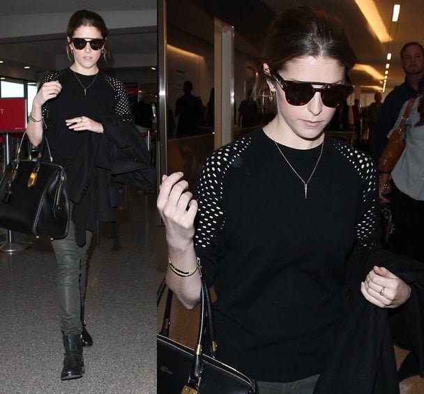 Anna Kendrick in a mesh-sleeved sweater and gold-heeled boots