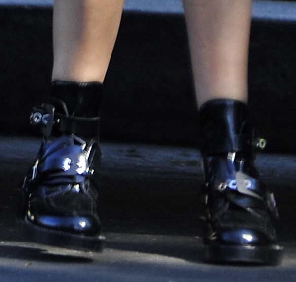 Ashley Tisdale wearing cutout buckled boots from Balenciaga