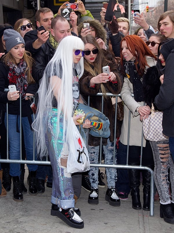 Lady Gaga was seen posing with her fans and signing autographs outside her Midtown hotel
