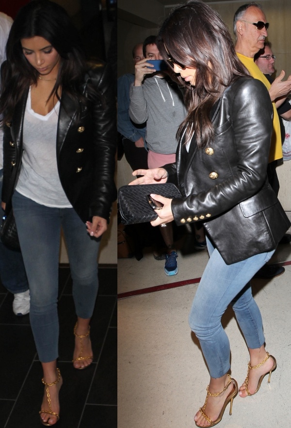Kim Kardashian in a black double-breasted leather blazer from Balmain over a white shirt and denim jeans