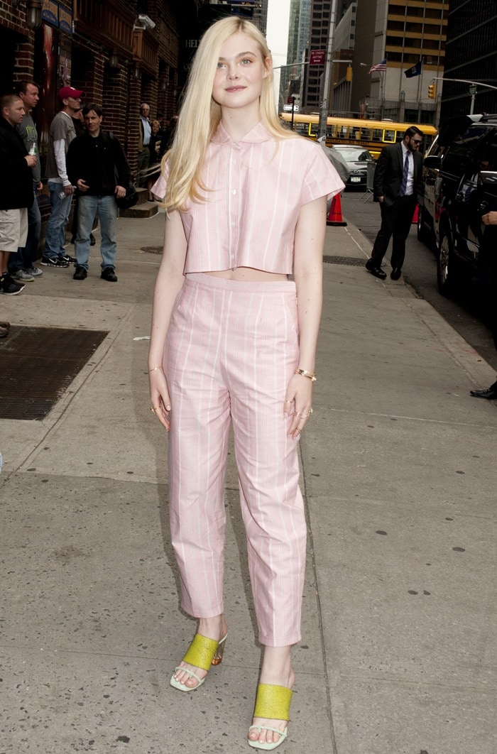 Elle Fanning wore a pink striped crop top with matching pants that looked like pajamas