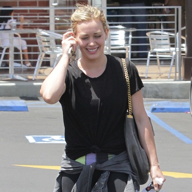 Hilary Duff spotted wearing black sportswear with a gray sweater tied around her waist in Beverly Hills on June 15, 2014