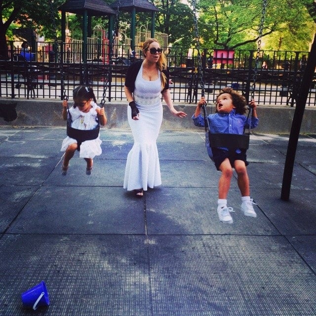 Mariah Carey pushing her fraternal twins, Monroe and Moroccan Scott, on the swings at a park in Manhattan