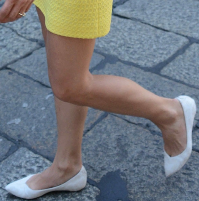Michelle Hunziker decked in simple white flats and a textured yellow shift dress at Cafe Trussardi in Milan, Italy, on June 20, 2014