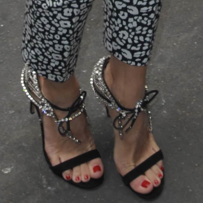 Olivia Palermo wearing a mixed-print three-piece outfit and crystal-detailed lace-up sandals