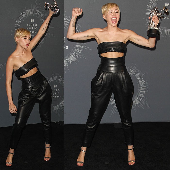 Miley Cyrus posing with her moonman trophy for the Video of the Year award inside the press room at the 2014 MTV Video Music Awards