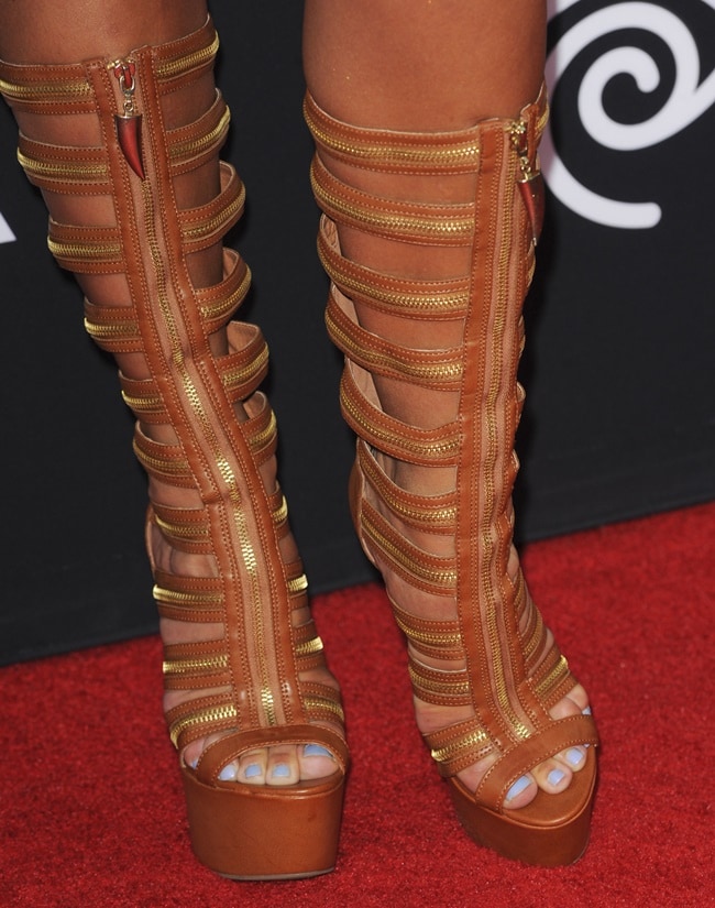 Natalie Burn wearing chunky knee-high gladiator sandals