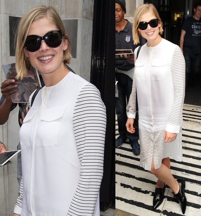 A pregnant Rosamund Pike wore a white long-sleeved shirtdress with black pointy lace-ups and black peepers