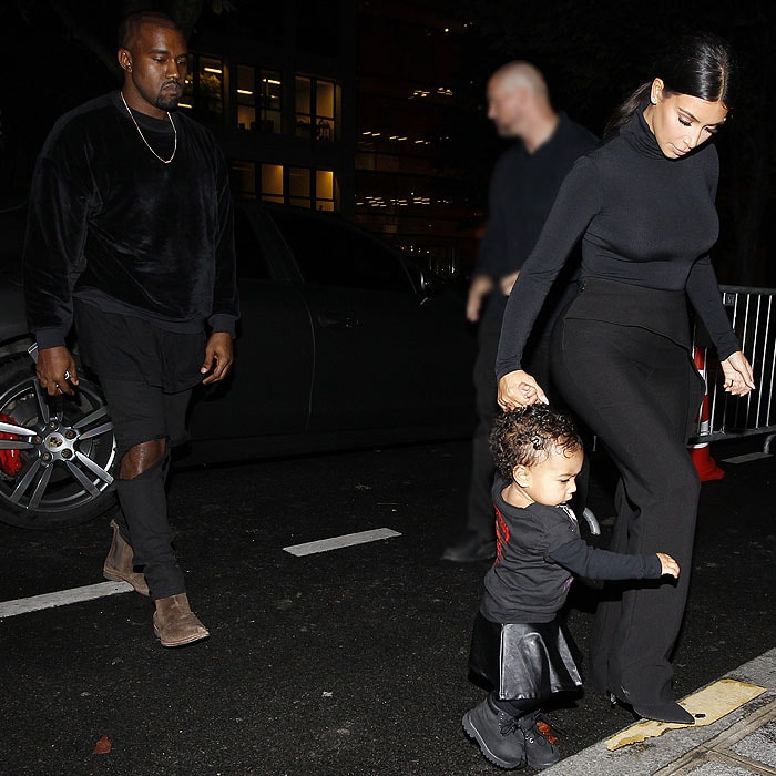 Kanye West and Kim Kardashian with North West heading to the Balenciaga runway show