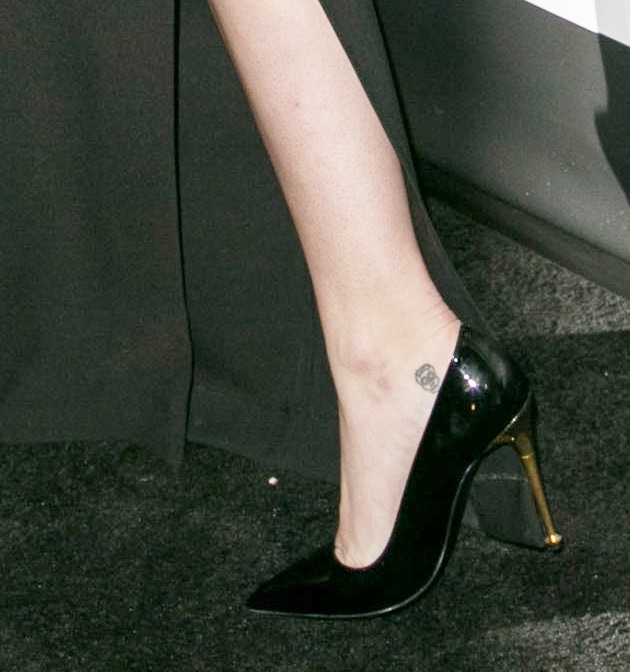 Miley wearing simple black pumps detailed with gold heels