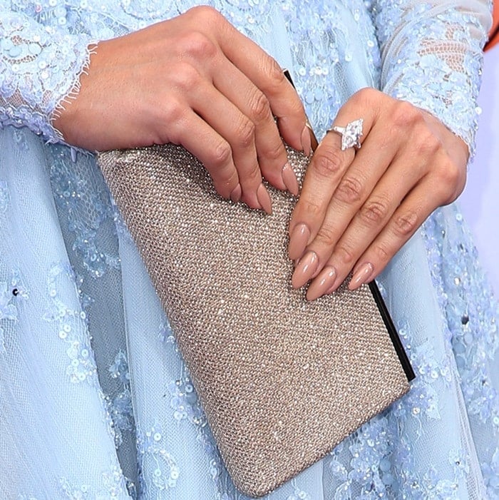 Jennifer Lopez showing off her rings and a stunning clutch