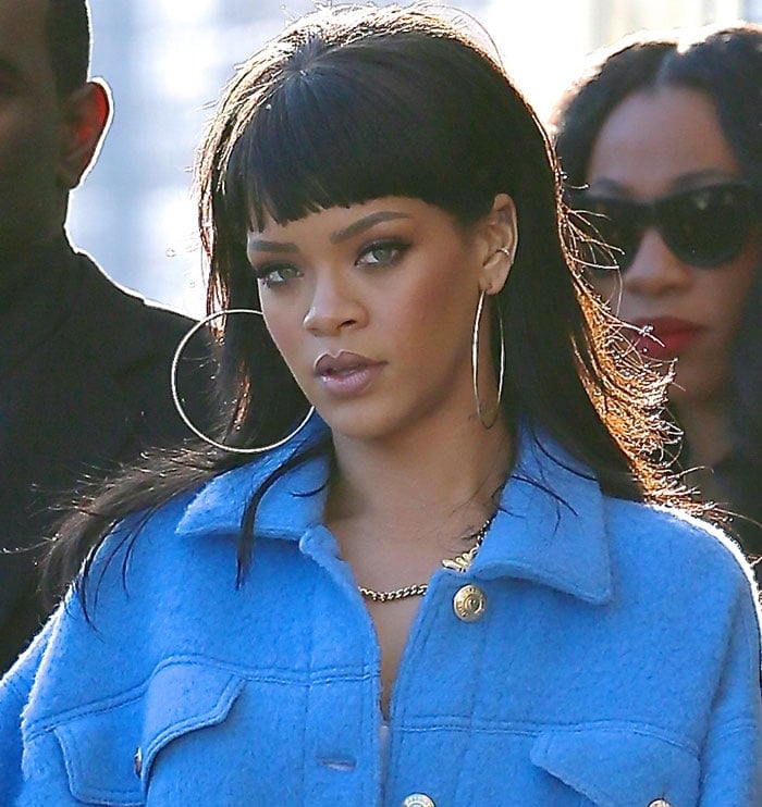 Rihanna accessorized with oversized hoop earrings and a Jeremy Scott x Melody Ehsani chain necklace