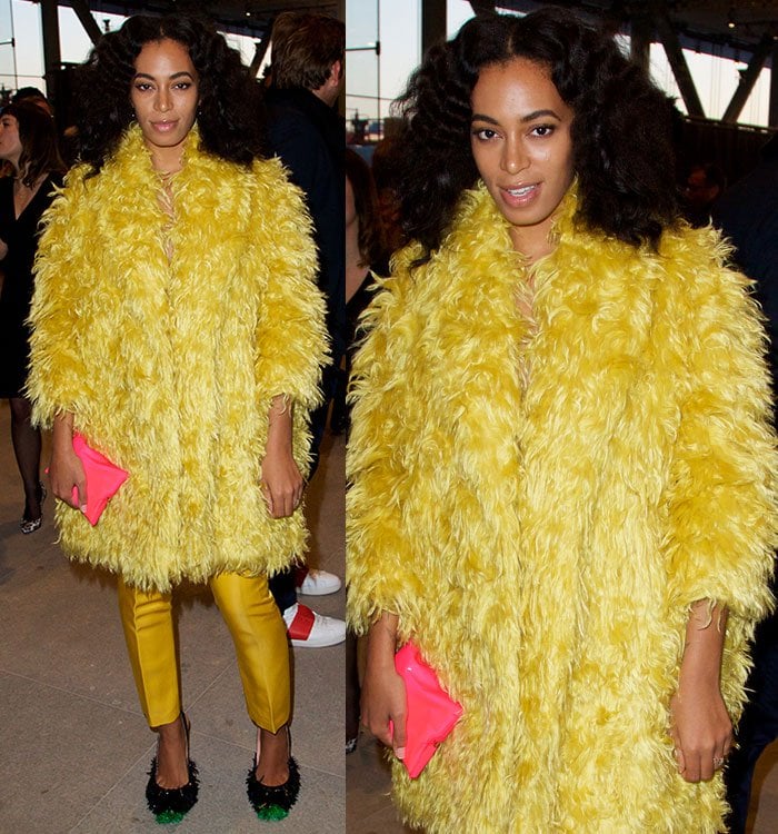 Solange Knowles covered up her slender figure in a huge yellow fur coat paired with mustard cropped satin trousers by Katie Ermilio and a bright pink clutch by Anya Hindmarch