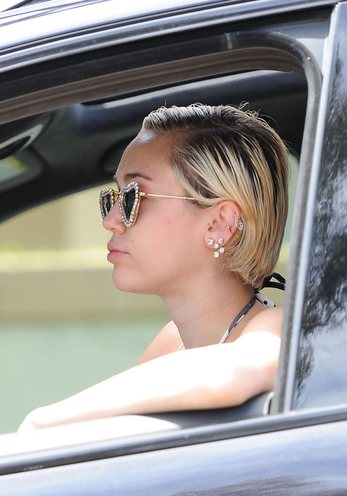 Miley Cyrus giving two big thumbs up as she arrives in Malibu in a bikini and trainers on April 30, 2015