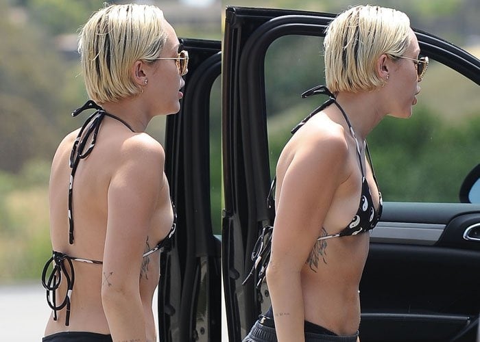 Miley Cyrus giving two big thumbs up as she arrives in Malibu in a bikini and trainers on April 30, 2015