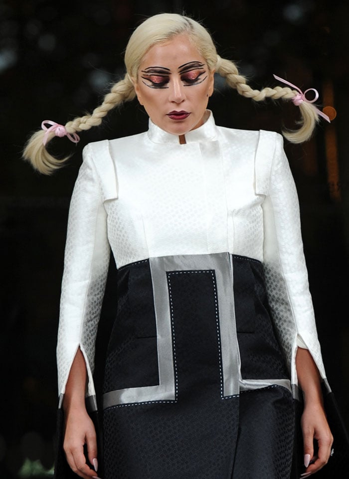 Lady Gaga wore Pippi Longstocking plait pigtails and crazy makeup with glittery red eye shadow and layers of thick black eyeliner, outlining her eyes, eyebrows, and eyelids
