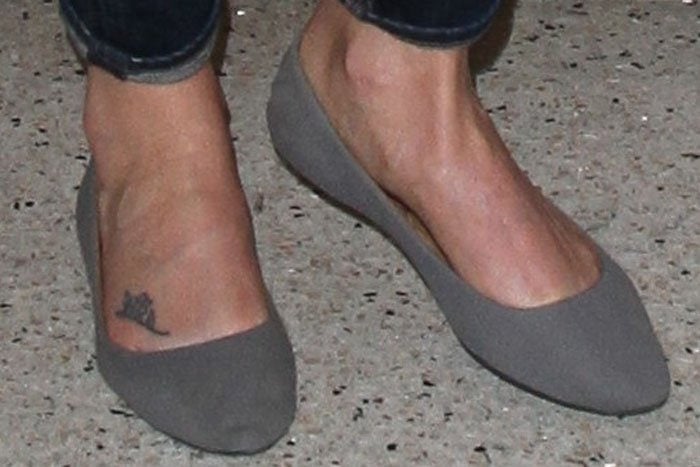 Charlize Theron wearing gray suede ballerina flats