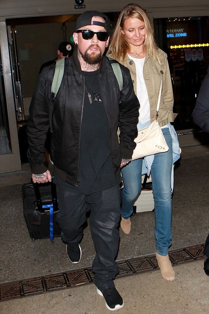 Benji Madden and Cameron Diaz holding hands as they make their way out of LAX Airport