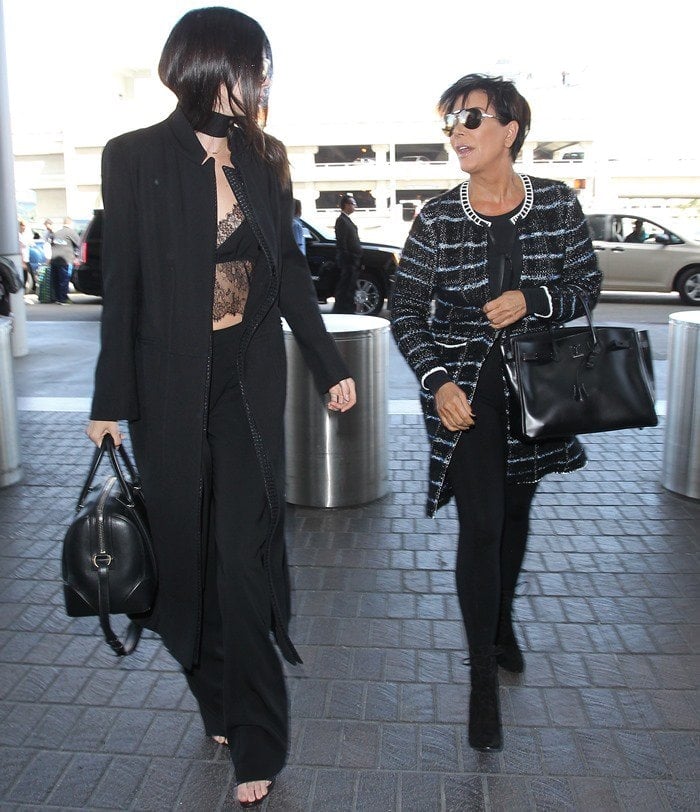 Kendall Jenner departs from Los Angeles International Airport (LAX) with her mother Kris walking back a few steps behind on September 28, 2015