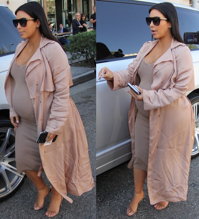 Kim Kardashian sported a wrap-front piqué coat by Lanvin over a nude bodycon midi dress