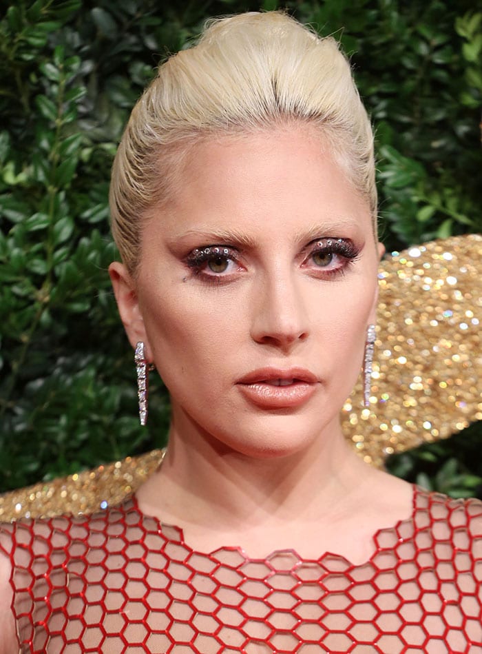 Lady Gaga oozed sex appeal in a custom-made red Tom Ford gown featuring all-over sequin embellishments
