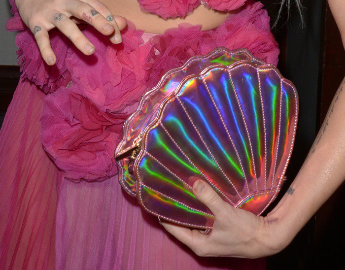 Miley styled the custom Ulyana Sergeenko outfit with a clam-shaped clutch