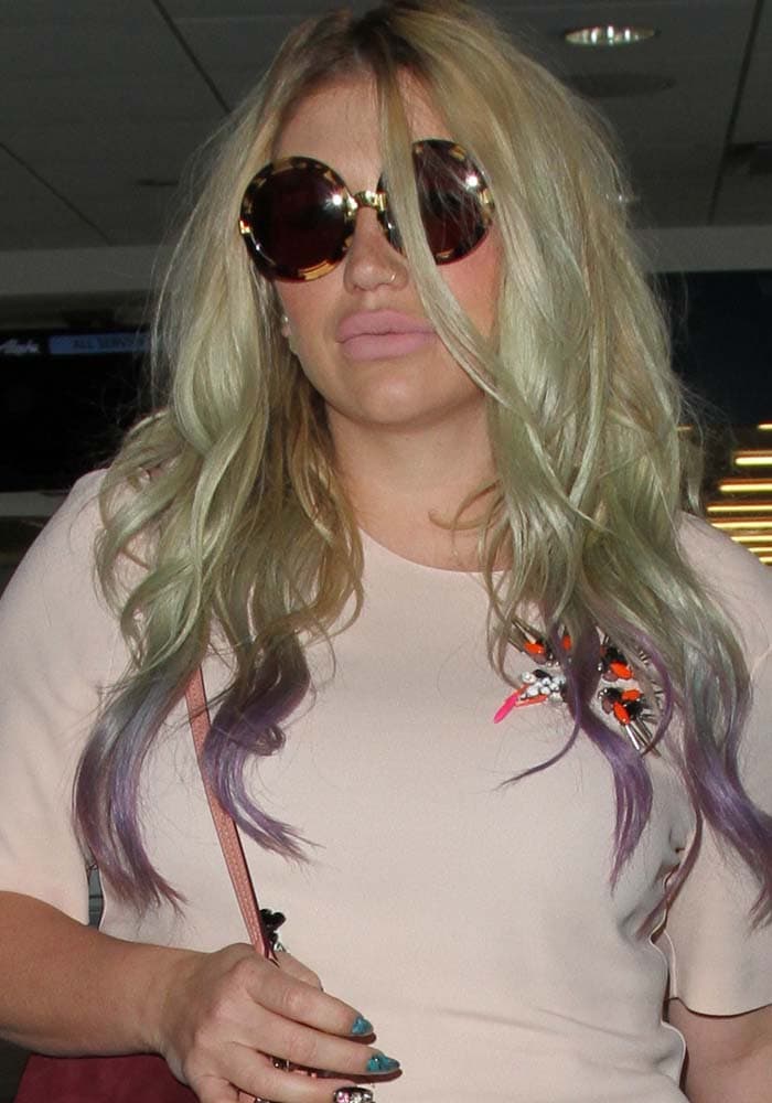 Kesha hid behind her round tortoise shell sunglasses